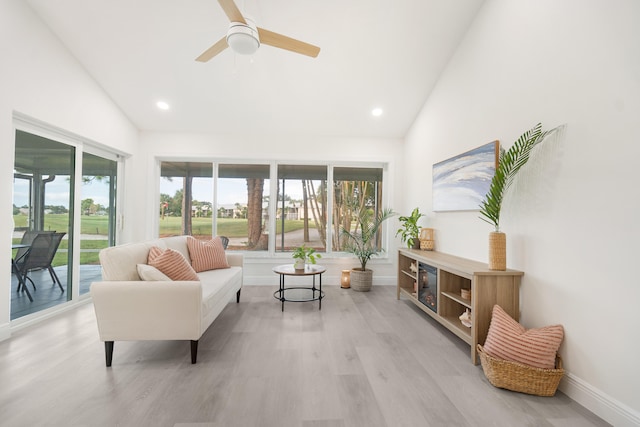 interior space with light wood-type flooring, high vaulted ceiling, and ceiling fan