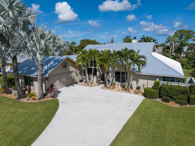 view of front of house featuring a garage and a front lawn