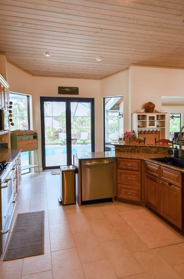 kitchen with light tile patterned floors, wooden ceiling, and stainless steel appliances