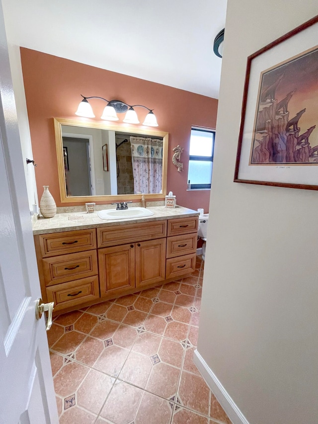 bathroom featuring tile patterned floors, toilet, and vanity