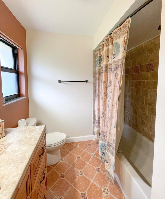 full bathroom with shower / tub combo with curtain, vanity, tile patterned flooring, and toilet