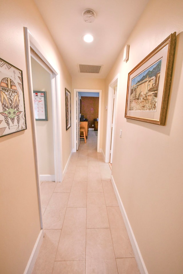 corridor with light tile patterned flooring