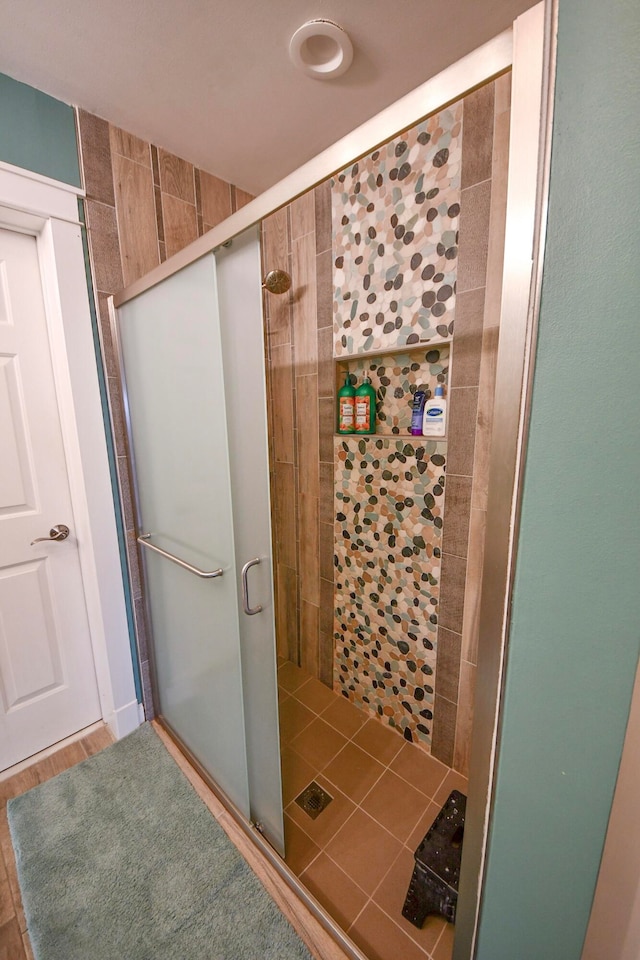 bathroom with a shower with shower door