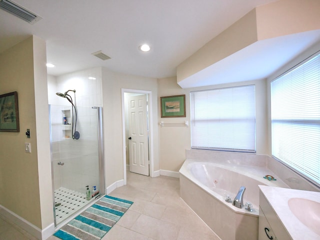 bathroom featuring tile patterned floors, vanity, and independent shower and bath