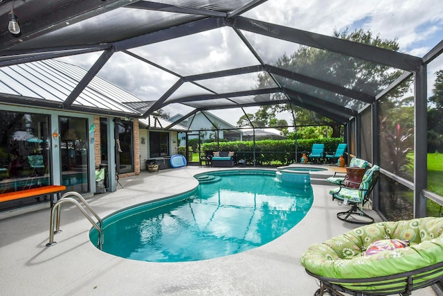 view of swimming pool featuring a lanai, an in ground hot tub, and a patio area