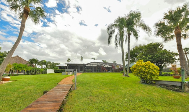 view of yard featuring glass enclosure