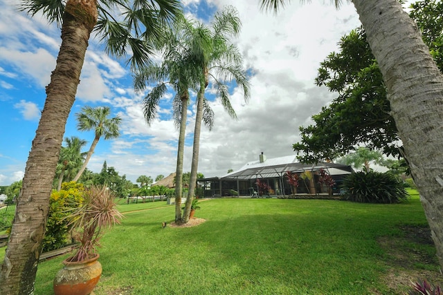 view of yard featuring glass enclosure