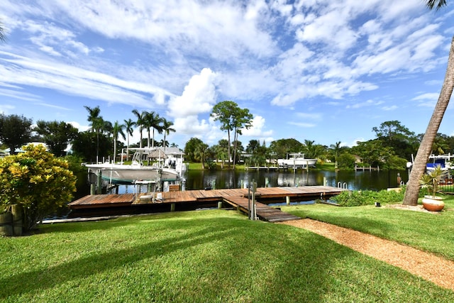 dock area featuring a water view and a lawn