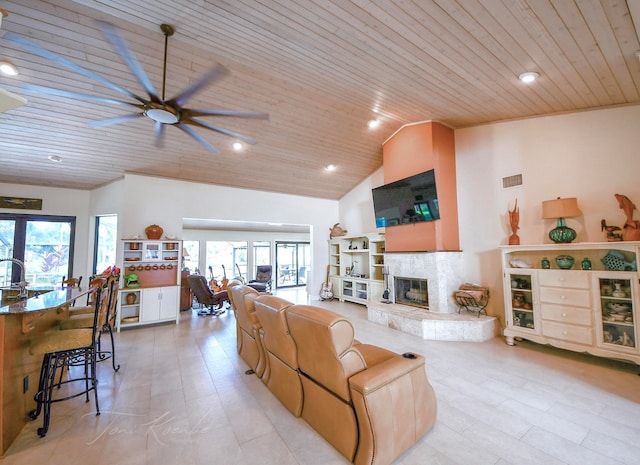 living room featuring high vaulted ceiling, a fireplace, ceiling fan, and wooden ceiling