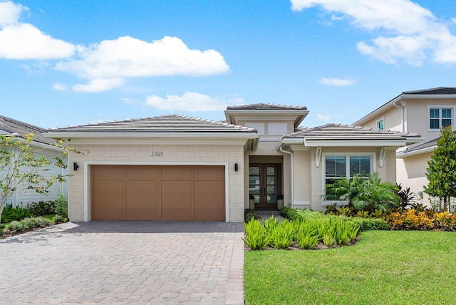 view of front of house with a front yard and a garage