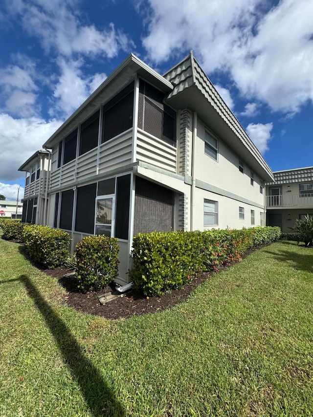 view of property exterior featuring a lawn