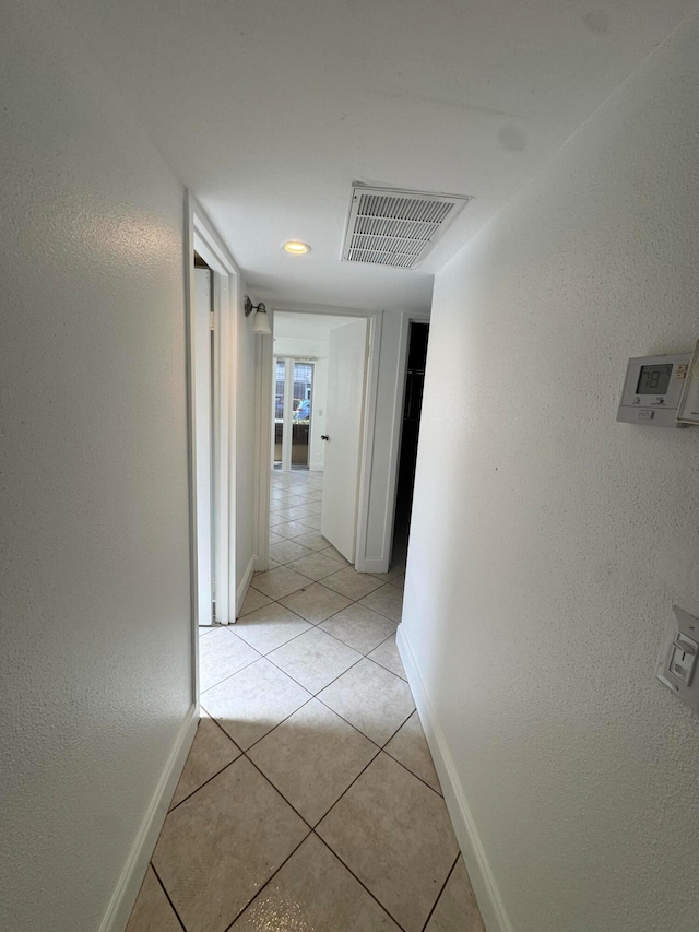 corridor with light tile patterned floors