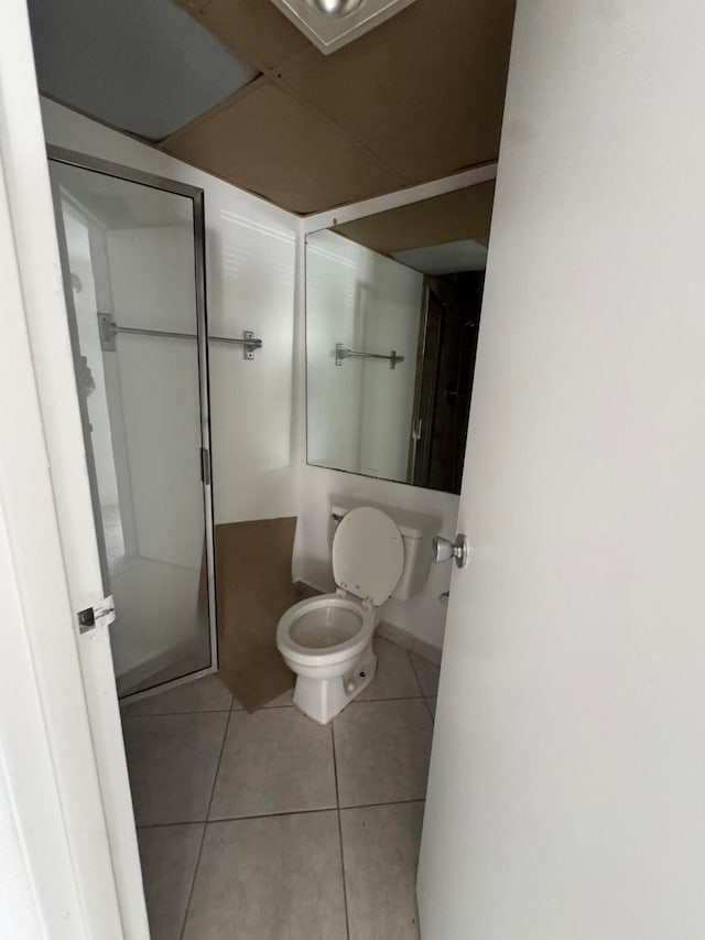 bathroom with toilet and tile patterned floors