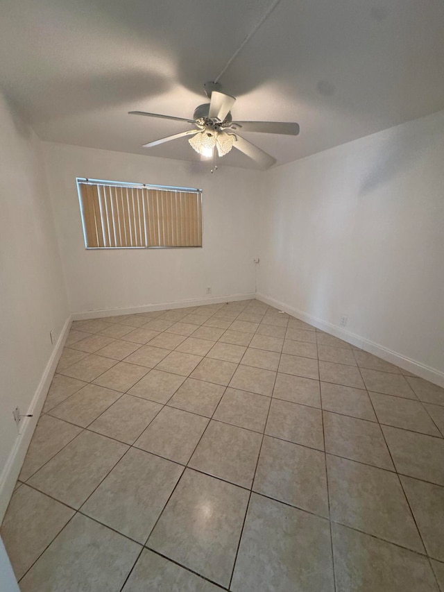 tiled empty room featuring ceiling fan