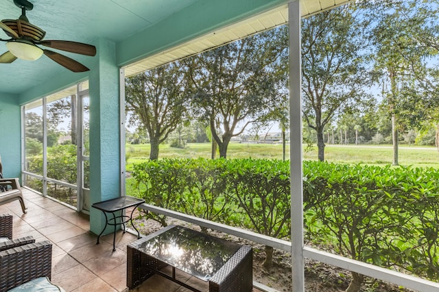 unfurnished sunroom featuring ceiling fan