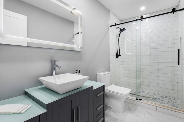 bathroom with vanity, toilet, and an enclosed shower