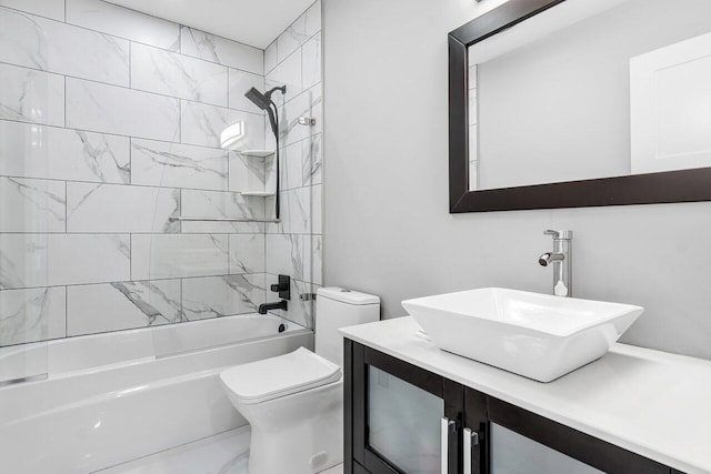 full bathroom with tiled shower / bath combo, vanity, and toilet