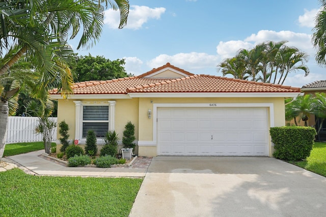 mediterranean / spanish-style house with a garage