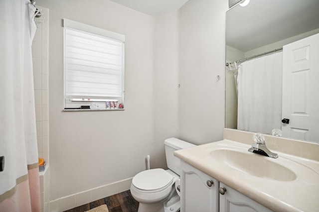 bathroom with toilet, vanity, a shower with shower curtain, and hardwood / wood-style flooring