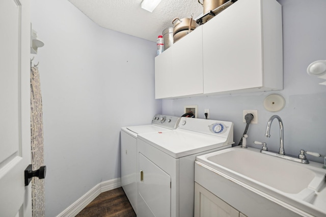 laundry room featuring sink, cabinets, separate washer and dryer, dark hardwood / wood-style flooring, and a textured ceiling