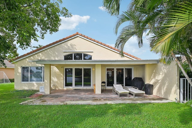 rear view of house with a patio area and a yard