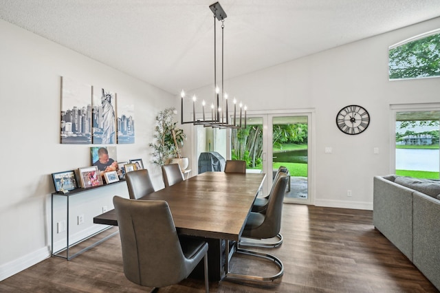 dining room with dark hardwood / wood-style flooring, high vaulted ceiling, a chandelier, and a textured ceiling