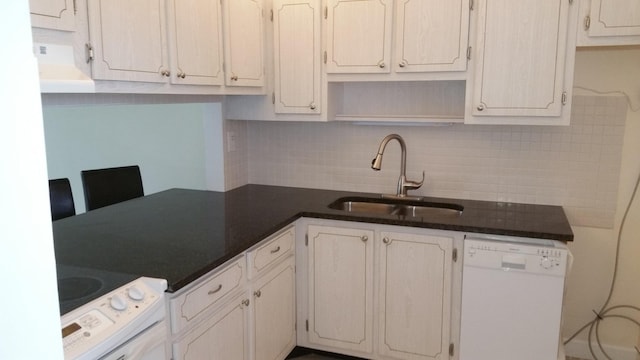 kitchen with decorative backsplash, sink, white appliances, and white cabinetry