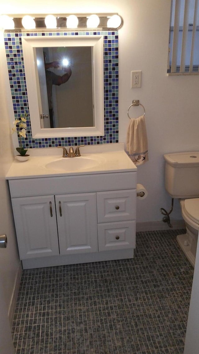 bathroom with vanity, tile patterned flooring, and toilet