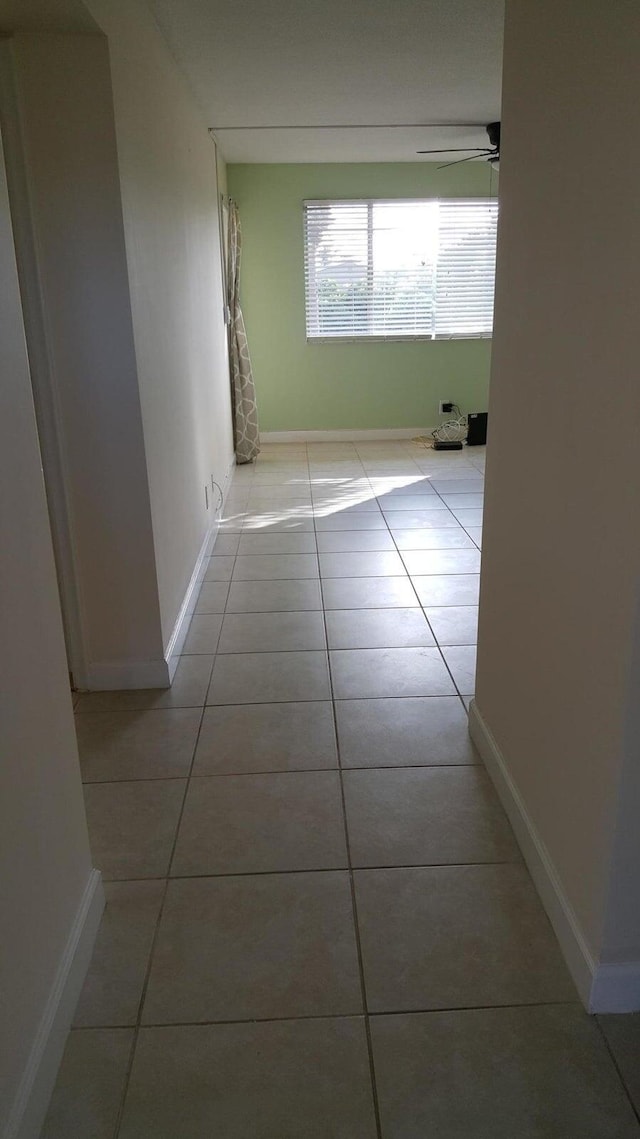 hall featuring light tile patterned floors