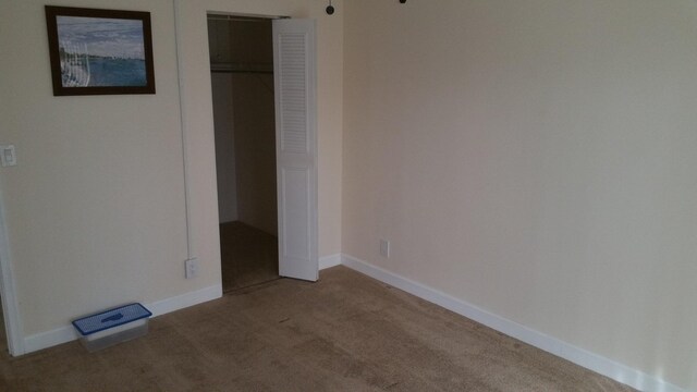 unfurnished bedroom featuring carpet floors and a closet