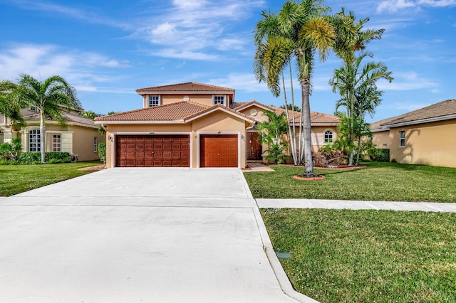 mediterranean / spanish home with a garage and a front lawn