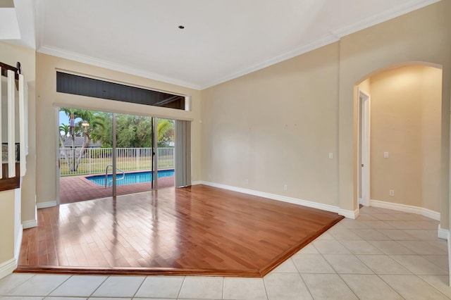 tiled spare room with crown molding