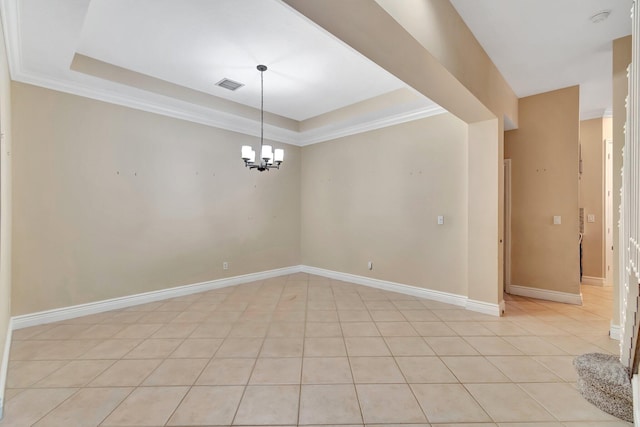 tiled spare room with crown molding, a chandelier, and a tray ceiling