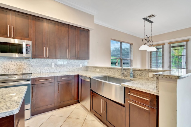 kitchen featuring sink, kitchen peninsula, and appliances with stainless steel finishes