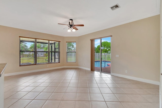 tiled spare room with ceiling fan