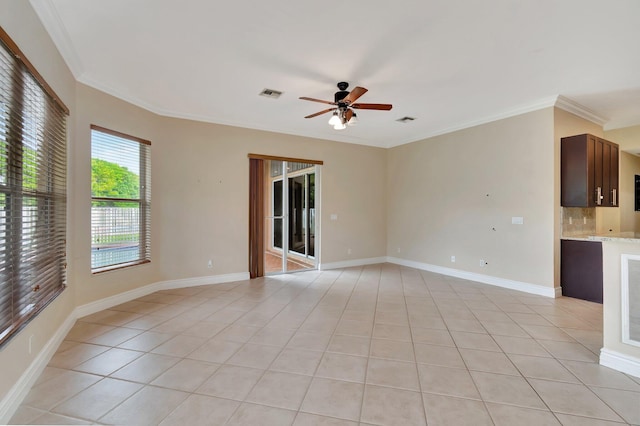 unfurnished living room featuring ceiling fan, ornamental molding, and light tile patterned floors