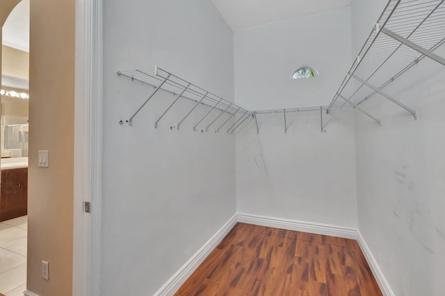 walk in closet with hardwood / wood-style floors