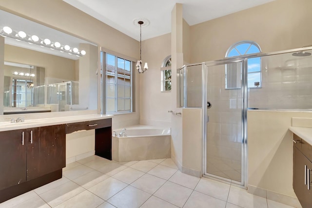 bathroom with tile patterned flooring, vanity, and a wealth of natural light