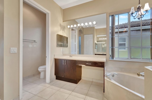 bathroom with vanity, tile patterned flooring, a bathing tub, and toilet