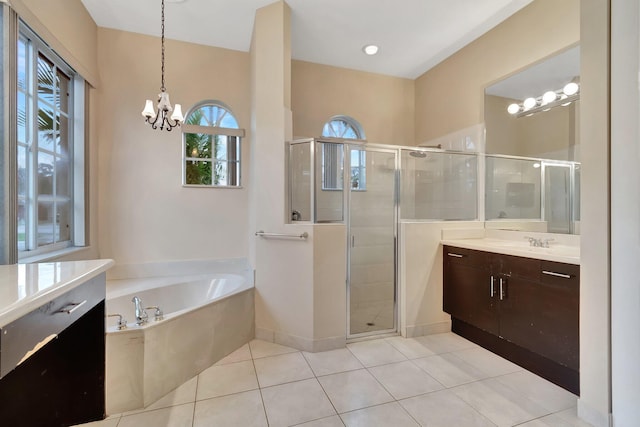 bathroom featuring vanity, tile patterned floors, an inviting chandelier, and plus walk in shower