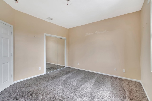 unfurnished bedroom featuring carpet and a closet