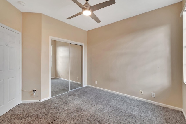 unfurnished bedroom featuring carpet flooring, ceiling fan, and a closet