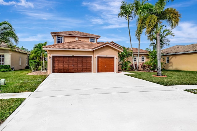 mediterranean / spanish-style house featuring a garage and a front lawn