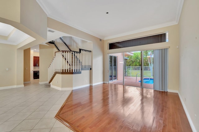 spare room featuring crown molding and light tile patterned flooring