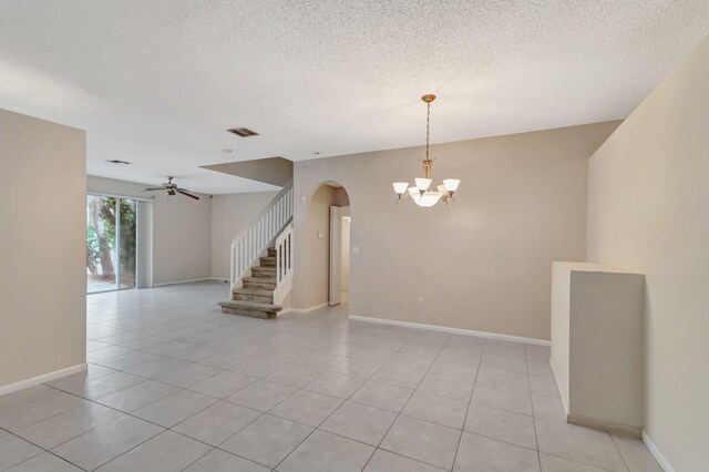 1102 Oakwater Dr, Royal Palm Beach, FL 33411 - spare room featuring arched walkways, a chandelier, light tile patterned floors, ceiling fan, and a textured ceiling