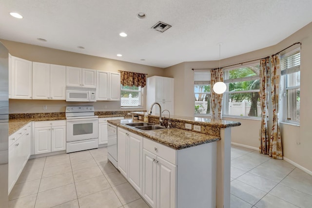 1102 Oakwater Dr, Royal Palm Beach, FL 33411 - kitchen with stainless steel refrigerator with ice dispenser, white microwave, light tile patterned floors, a chandelier, and white cabinets