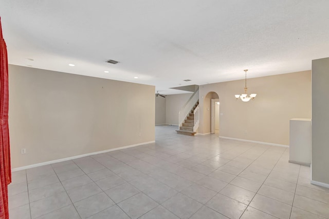 1102 Oakwater Dr, Royal Palm Beach, FL 33411 - empty room with a chandelier, arched walkways, baseboards, light tile patterned floors, and recessed lighting
