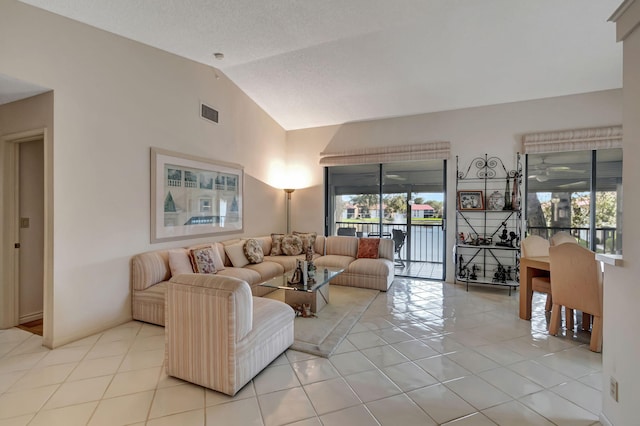 living room featuring light tile patterned floors and vaulted ceiling