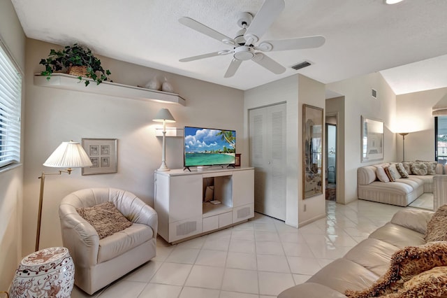 tiled living room featuring ceiling fan