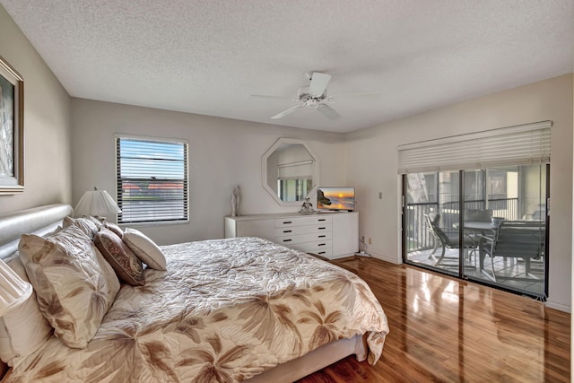 bedroom featuring hardwood / wood-style flooring, access to outside, a textured ceiling, and ceiling fan